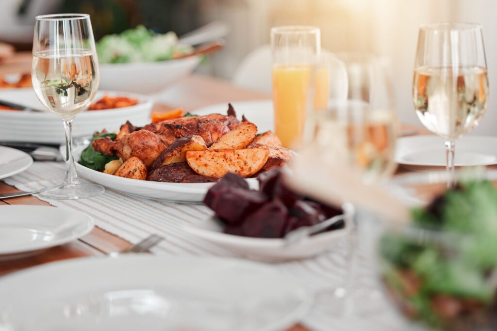 Food, party and celebration with table in dining room for event, thanksgiving and gathering. Nutrit.