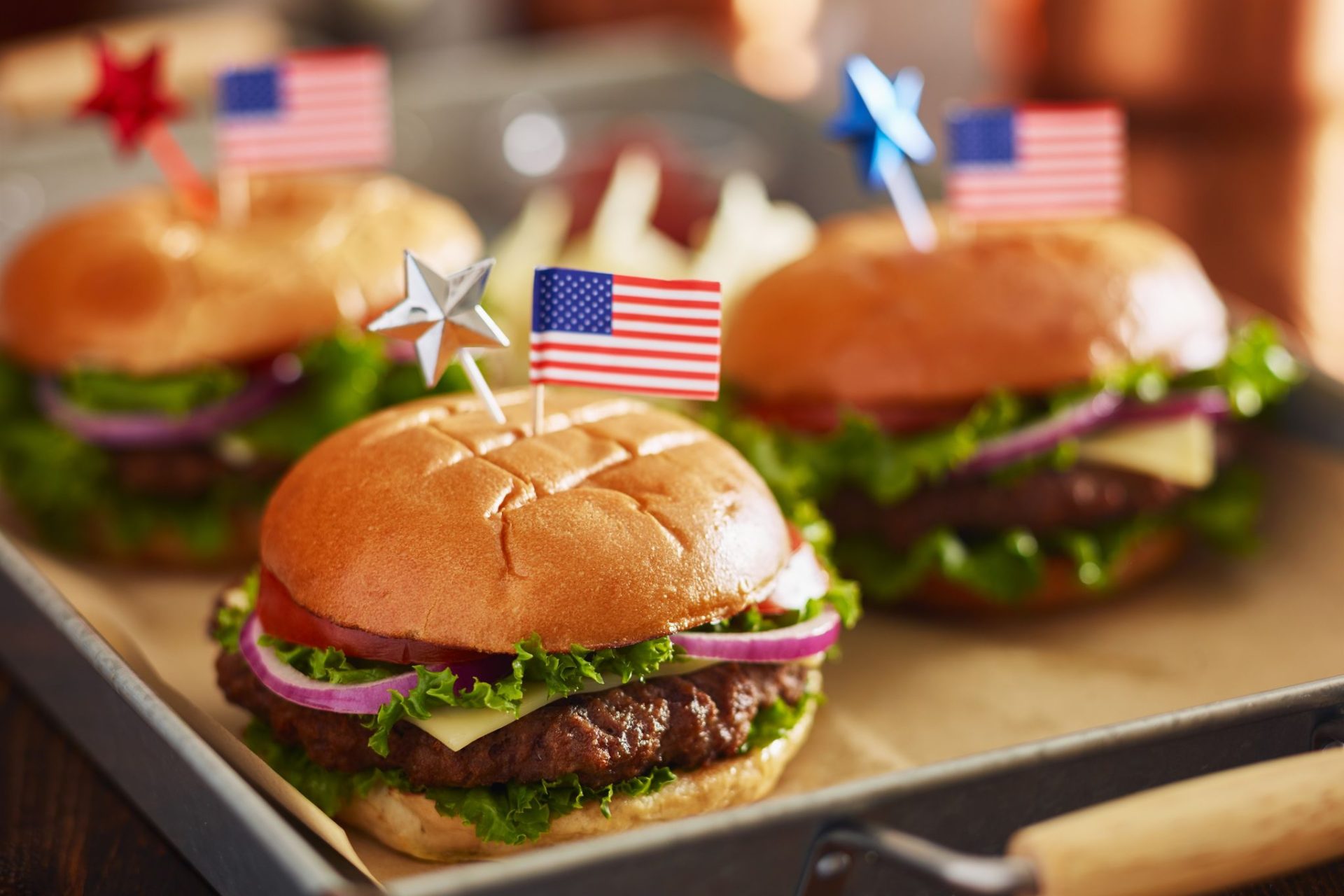 cheeseburgers with american flags for 4th of july picnic